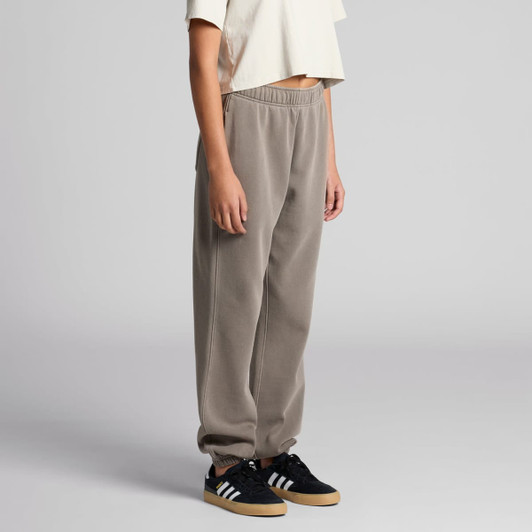 Faded grey track pants with an elastic waistband and cuffed ankles, paired with black sneakers. 