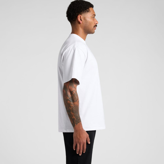 A side view of a model wearing a plain white T-shirt with loose sleeves and a branding logo.