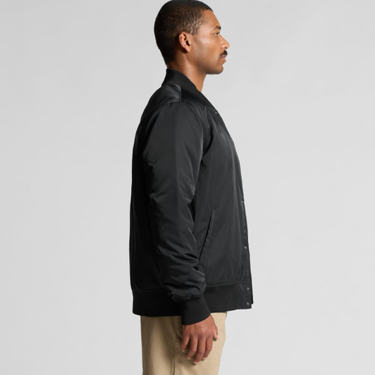 A black college bomber jacket displayed on a model in profile view, featuring a logo on the chest and ribbed cuffs.