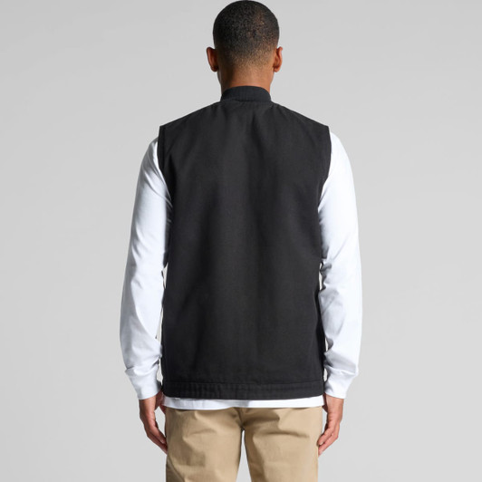 A black heavy vest with a clean back design, worn over a long-sleeve white top. Features a logo.