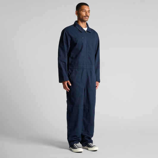 Navy canvas coveralls with long sleeves and zip front, featuring a logo on the chest. Suitable for workwear.