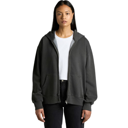 A woman wearing a faded dark grey zip hoodie, featuring a front pocket and a logo.