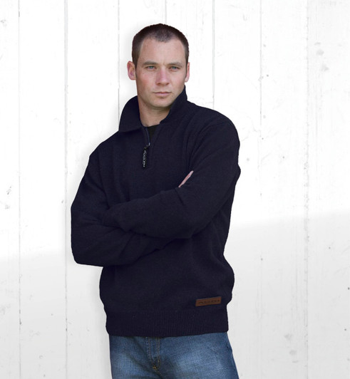 A black Agri Station Boundary Jersey with a half-zip collar, worn by a model against a textured white background.