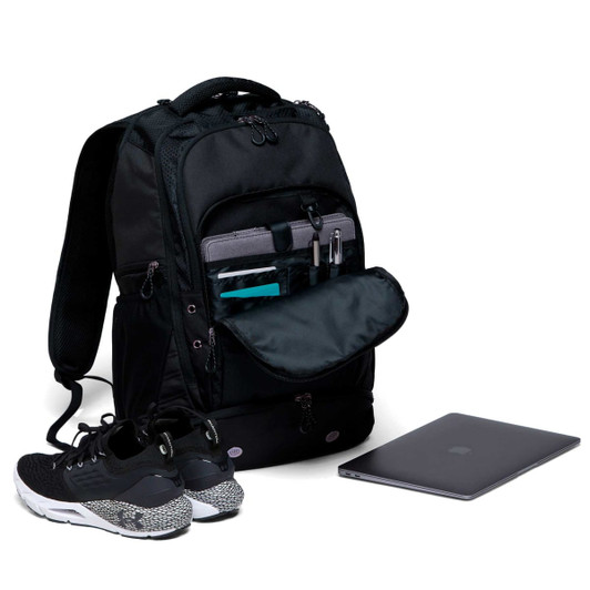 A black backpack displays multiple compartments, including one for a laptop, alongside a pair of shoes and a laptop.