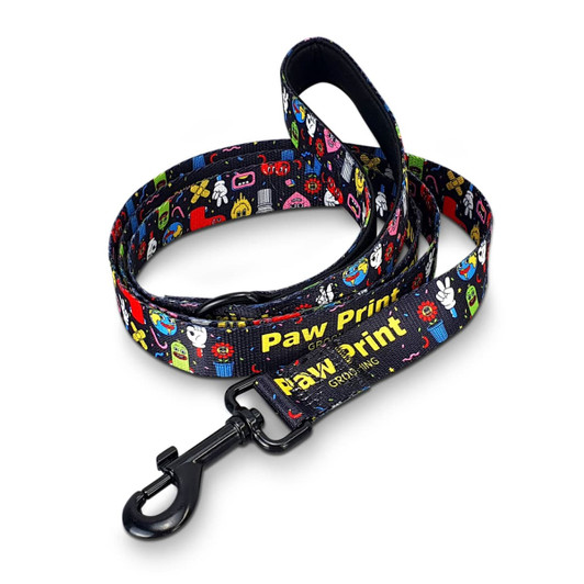 A dog leash featuring a vibrant pattern of cartoonish designs, primarily in black with colourful prints and a clip attachment.