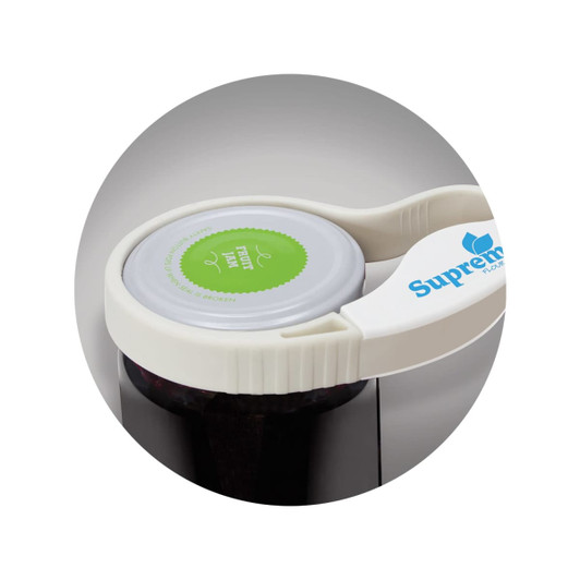 A white jar and bottle opener with a logo, positioned on a jar lid, featuring a green circular label.