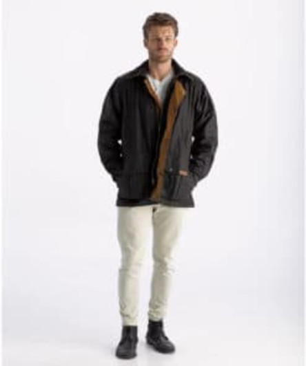 A jacket in brown and black with a logo, modelled by a person wearing light trousers and boots.