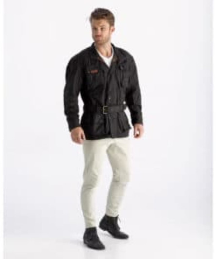 A trench coat in brown worn by a male model, featuring a belt and styled with light-coloured trousers.