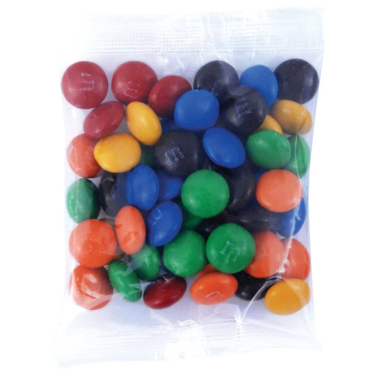 A clear bag filled with a variety of colorful M&M's, including red, blue, green, yellow, orange, and black candies.