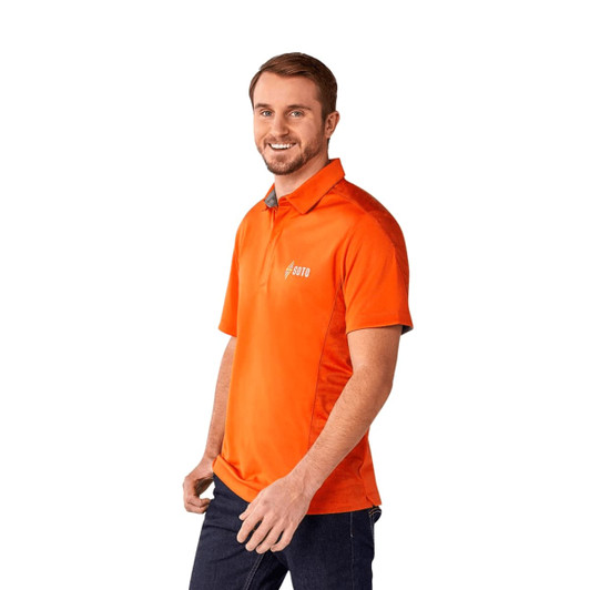 An orange short sleeve performance polo shirt with a logo, worn by a man smiling.