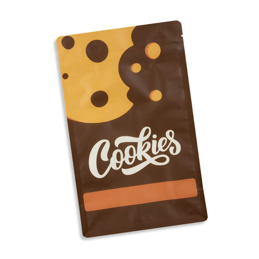 A small foil flat bottom pouch in brown with yellow and black cookie designs, featuring a logo.