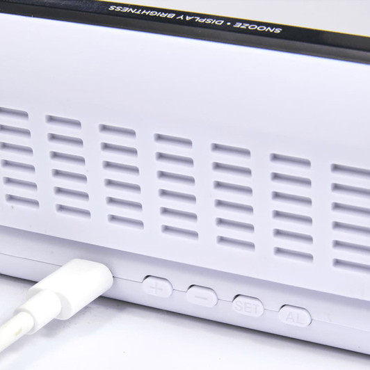 A white digital power clock with buttons and a charging port, featuring a sleek design and a logo.