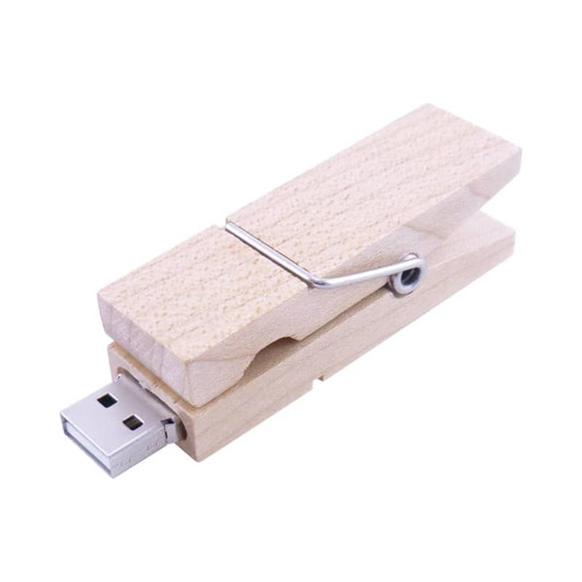 A wooden peg flash drive with a silver clip and a USB connector.
