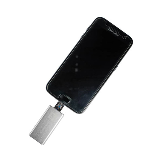 A silver OTG USB 3.0 drive connected to a black smartphone, displaying a sleek, modern design.