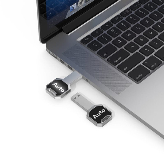 A silver Auto LED flash drive plugged into a laptop, featuring a sleek design and a logo.