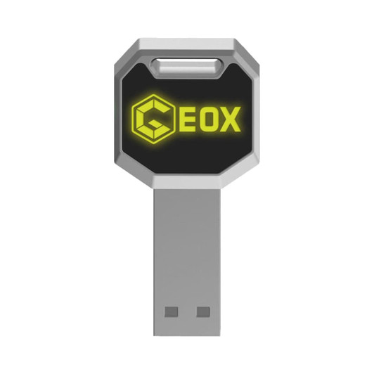 A silver and black LED flash drive with a hexagonal shape and a logo.