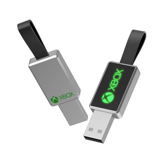A silver USB flash drive with a black strap, featuring a green logo on one side.