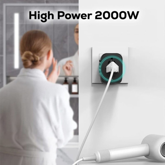 A high-powered travel adaptor featuring multiple ports in black with a sleek design, plugged into a wall socket.