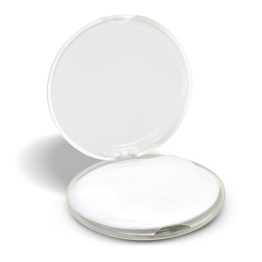 A round, transparent hand soap travel case, featuring a white soap disc inside.