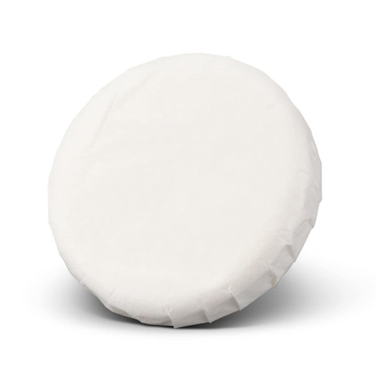 A round, white soap wrapped in paper, featuring a plain surface and a smooth texture.