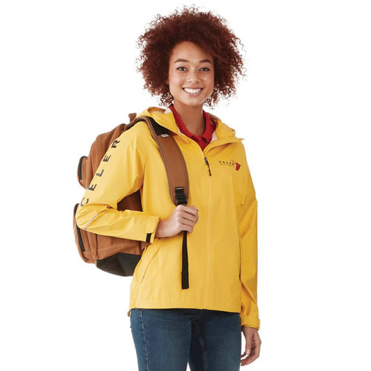 A yellow women's rain jacket with a hood, worn by a smiling person holding a brown backpack.