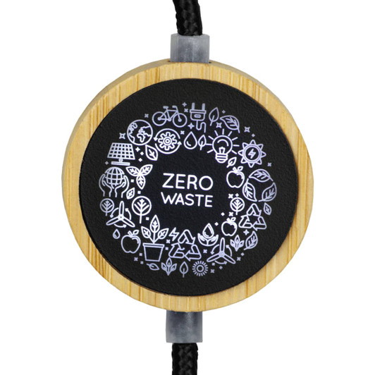 A circular charging cable with a black and bamboo design, featuring a "Zero Waste" logo and various eco-themed icons.