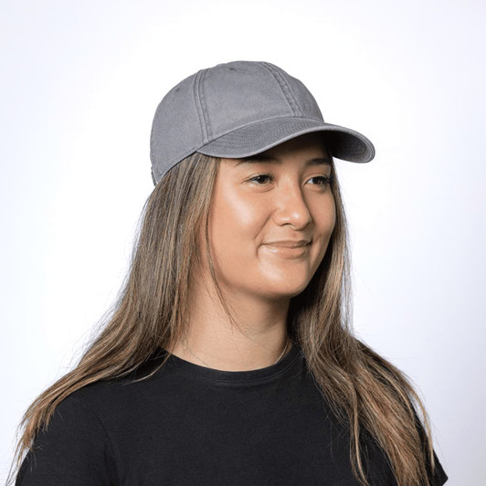 A grey organic washed cotton cap with a curved brim, featuring a logo on the side.