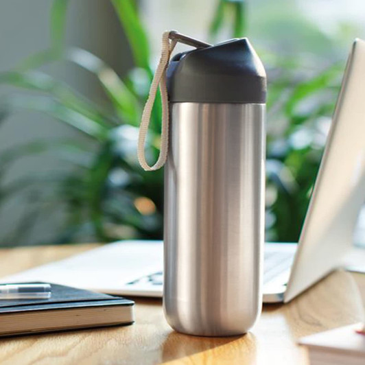 A drink bottle in a sleek silver metal finish, featuring a grey cap and a removable strap.