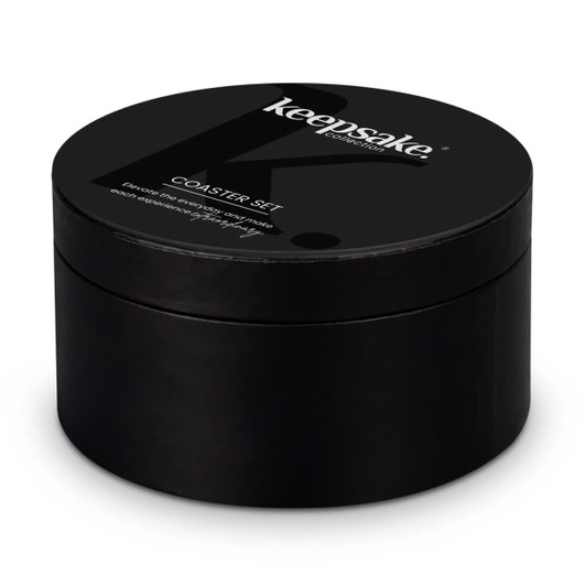 A black round box containing a coaster set, featuring a logo on the top.