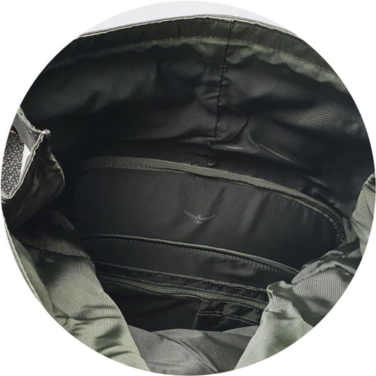 An interior view of a green Osprey Arcane Roll Top Backpack, showcasing its storage compartments and lining.