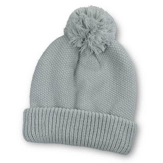 A soft grey beanie with a pom-pom on top and a ribbed cuff, featuring a logo.