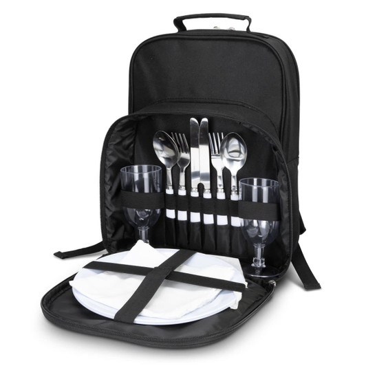 A black picnic backpack with cutlery, wine glasses, napkins, and plates neatly arranged inside.