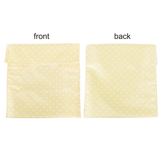 A reusable food pouch in yellow with white polka dots and a Velcro closure, featuring front and back views.