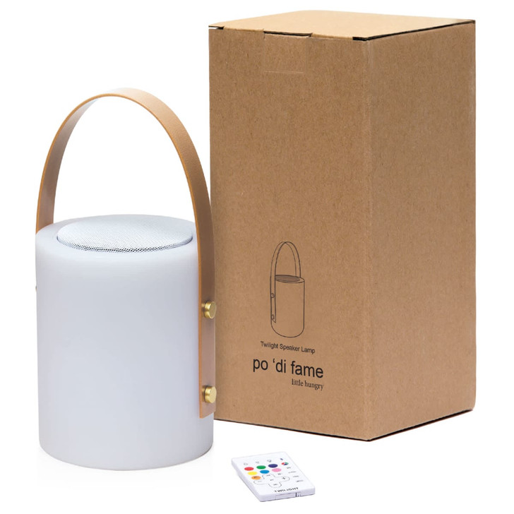 A white cylindrical speaker lamp with a leather handle, accompanied by a brown cardboard box and a remote control.