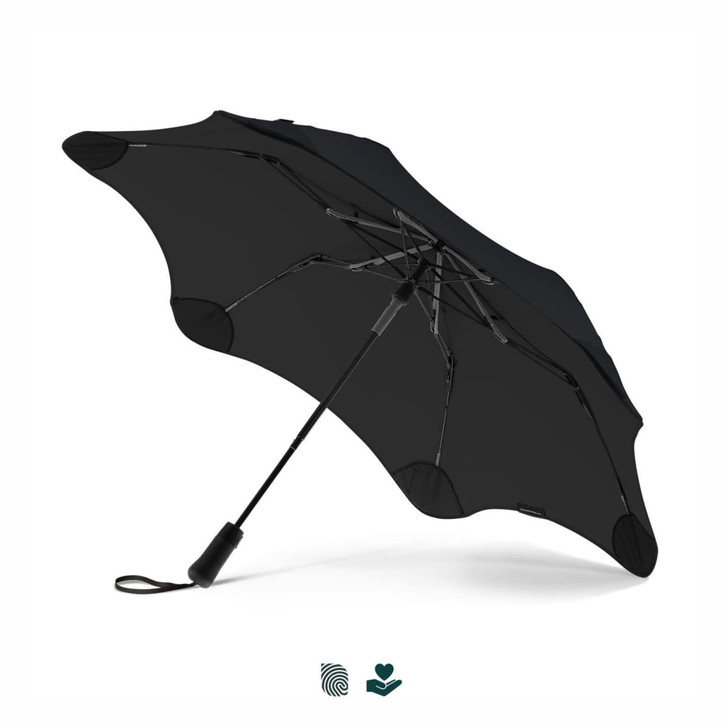 A black BLUNT Metro UV umbrella with a unique design and a sleek handle, featuring a logo on the handle.