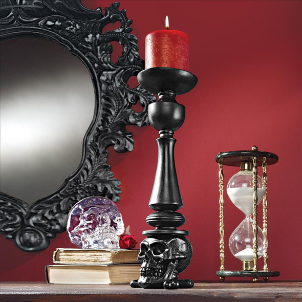 Dramatically rising over a foot tall, our Shadow of Darkness Candlesticks are inspired by the macabre skull and bones on their hand-painted faux ebony bases. Ready to hold your pillar candles, our gothic designer resin collectibles are available only at Design Toscano! Do not leave lit candles unattended. Candles not included.  Each: 4&frac12;Wx4Dx14H. 1 lb.