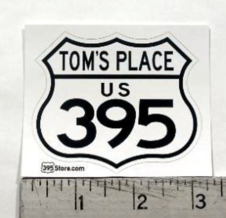 395 sticker that says "Tom's Place" across top.