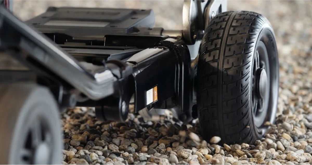 Close view of the EP4 rear suspension and flat-free tire on gravel