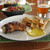 A plate of Chicken Thighs and Fries A plate of Chicken Thighs and Fries