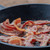 Thick Cut Smoked Bacon Frying in a Pan Thick Cut Smoked Bacon Frying in a Pan