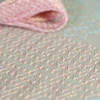 Olympus Lame thread. Hanaikada (Cherry Blossom pink). "Hanaikada" is a word that describes the scene of so many cherry blossom petals that they cover the surface of the water and float down the river like a raft. The deep pink of the overlapping petals and the bright spring sunlight are expressed.