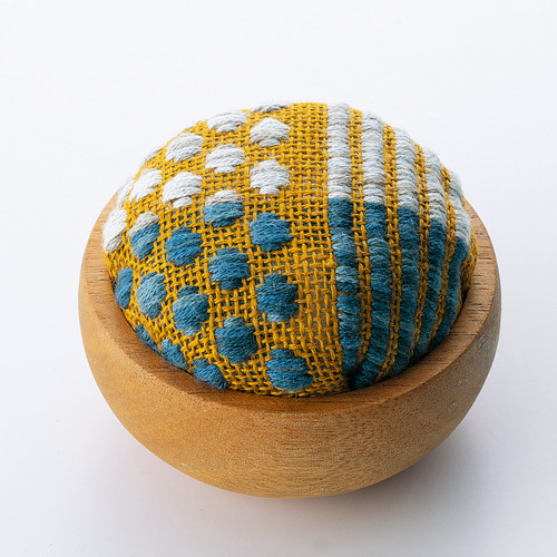 Kogin pincushion in mustard, white and turquoise. Timber base. 