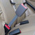 A gray, 7", Rigid Seat Belt Extension buckled upright in the back seat of a Jeep