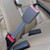 A gray, 7", Rigid Seat Belt Extension buckled upright in the back seat of a Daihatsu