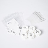 beU By ORGANO sampling kit including plastic sample jars, ziplock bags, and spatula for skincare product distribution and promotional use
