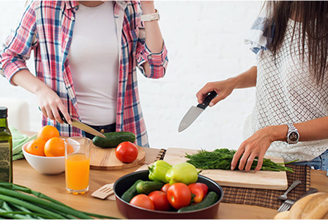 Two people chopping vegetables