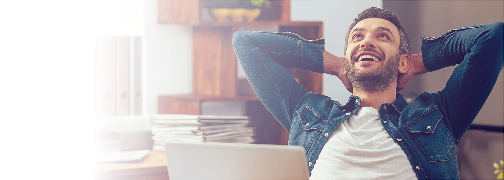 Man relaxing while using computer.