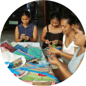 Women crafting around table for Bags For Life program.