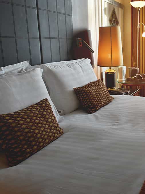 Hotel bed view with lamps and pillows