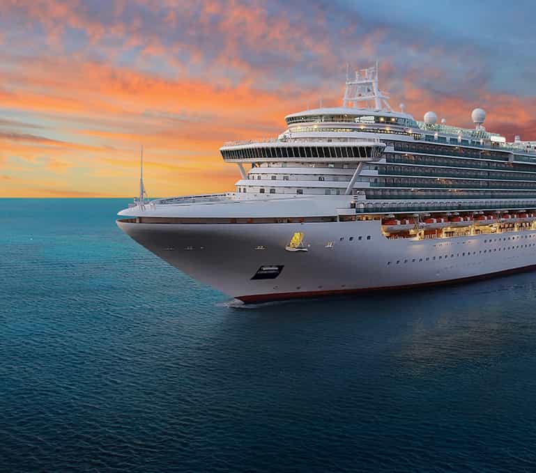 Large Cruise ship on ocean with sunset.